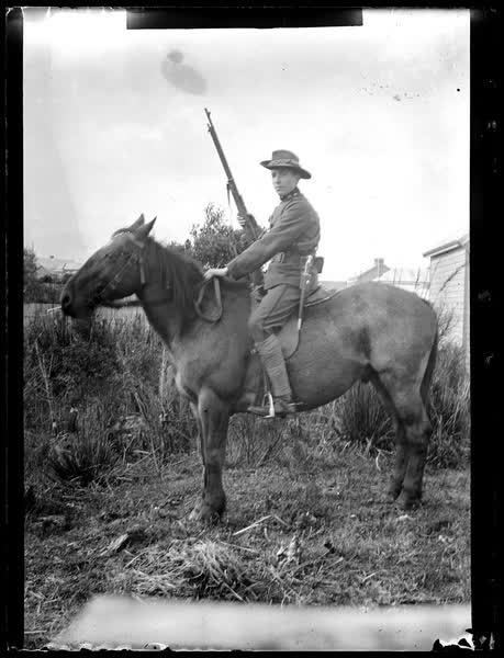 Man on a horse with a gun, 1900