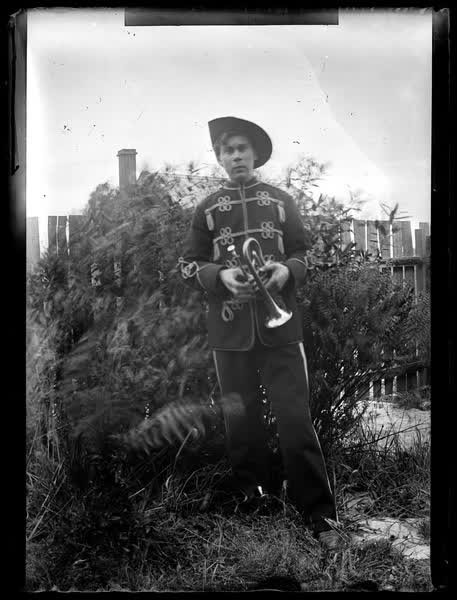 Man holding a bugle, 1900