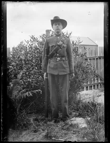 Man in uniform with a gun, 1900
