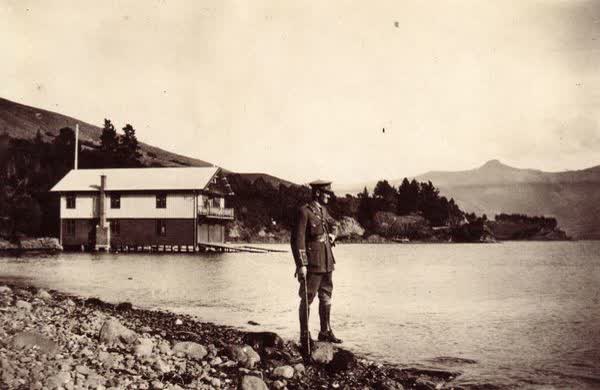 Soldier in front of Akaroa Boatshed, 1918