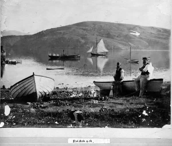 Two men leaning on a boat, 1890