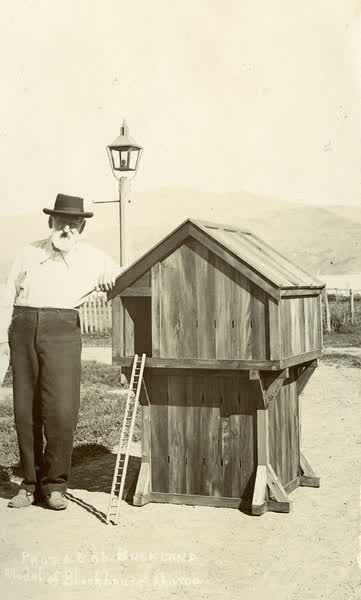 Man next to a model of a BlockhouseJan Shuttleworth collection, 1906