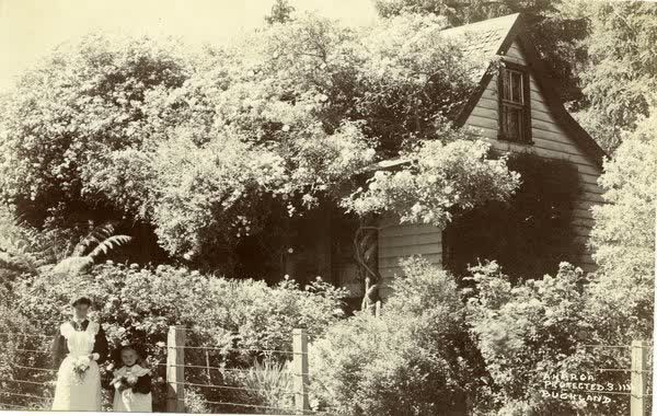 Woman and child standing in front of fence at Funnells CottageJan Shuttleworth collection, 1911