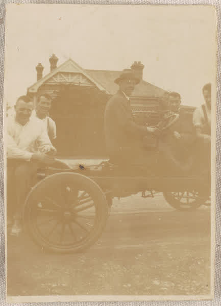 Car outside Family Nisbit Grocers, 1920