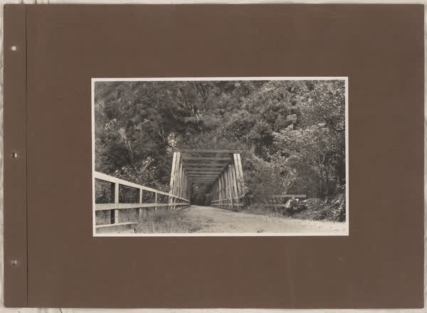 Man standing beside a bridge, 1920