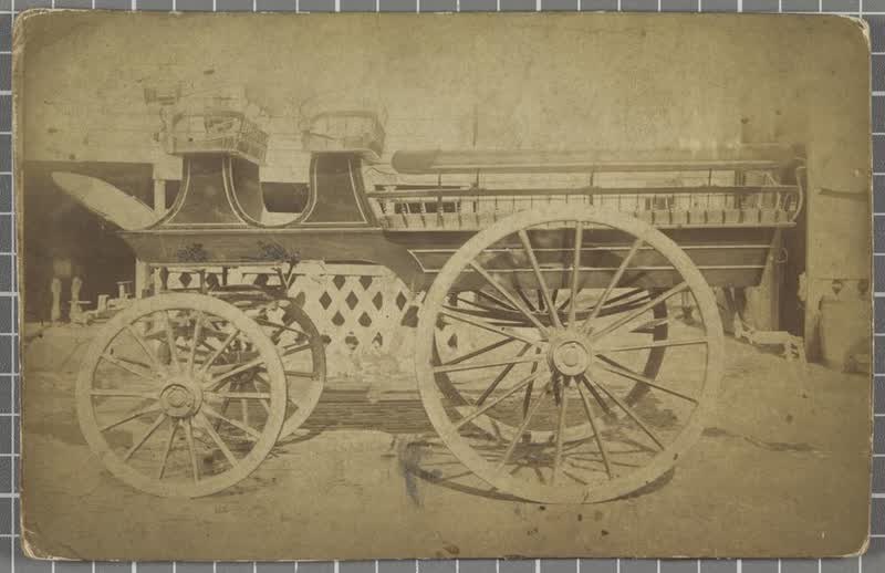 Four-wheeled horse-drawn open carriage with two front seats and side benches, 1887