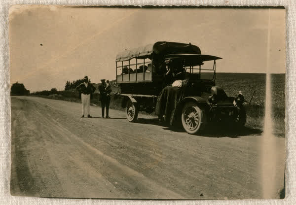 Standing next to a bus, 1900
