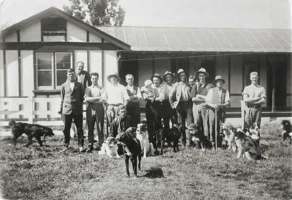 Men outside a house, 1900