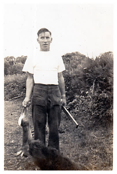 Clarence Walker with dead rabbit, 1950