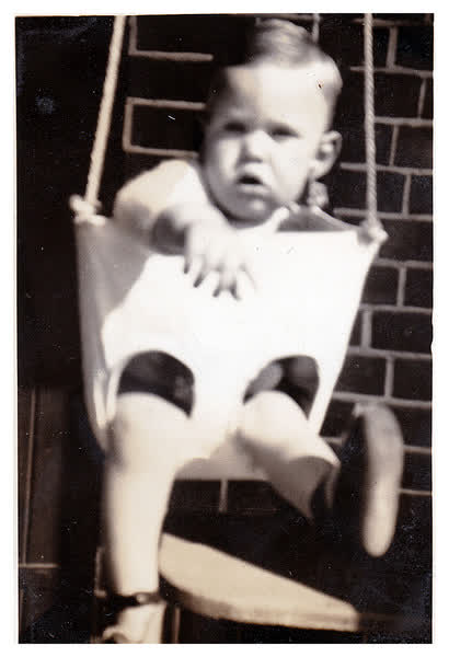 Warren in chair swing, 1940
