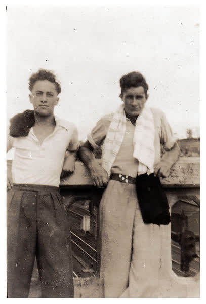 Men standing on bridge overlooking railway, 1942