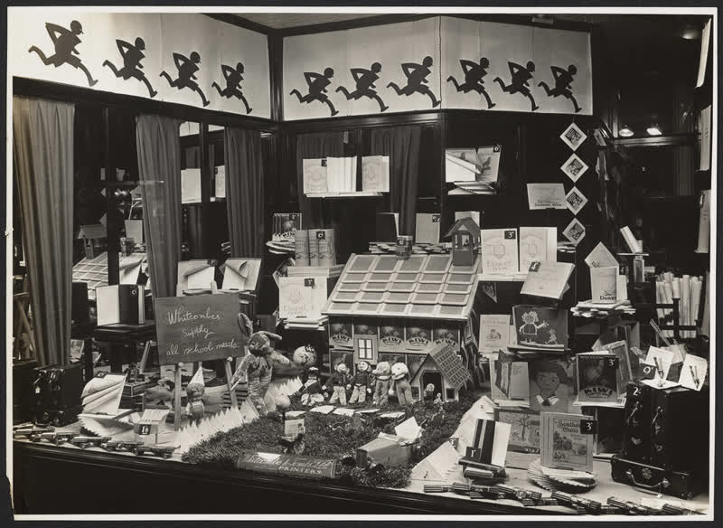 'Whitcombes supply all school needs' window display, 1930