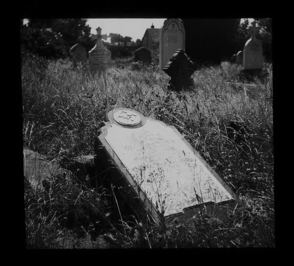 A downed headstone in Barbadoes Cemetery, 1945
