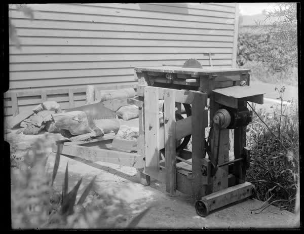Saw cutting a log, 1900